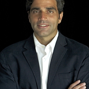 dressed in a dark suit with a white shirt