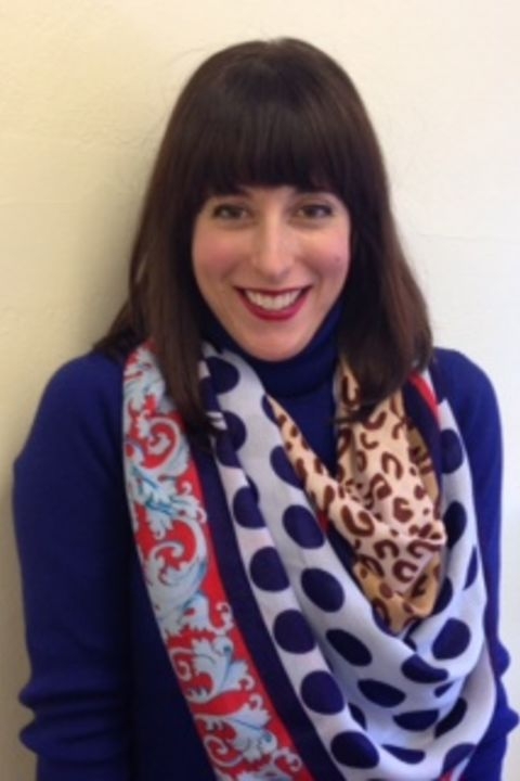 Kristin Stasiowski wearing a paisley scarf, with a high neck purple shirt.