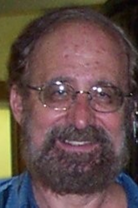 Emanuel Paparella smiling, wearing glasses fully bearded