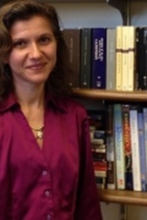 Roberta Francesca Seaman standing in front of bookshelves