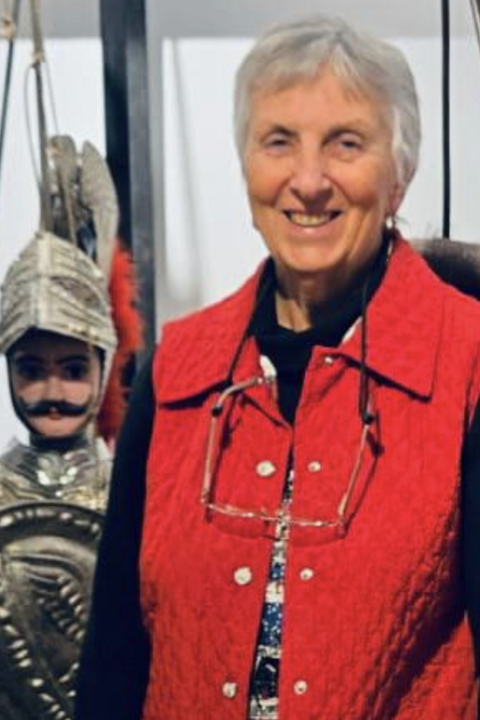 Jo Ann Cavallo standing in front of a puppet